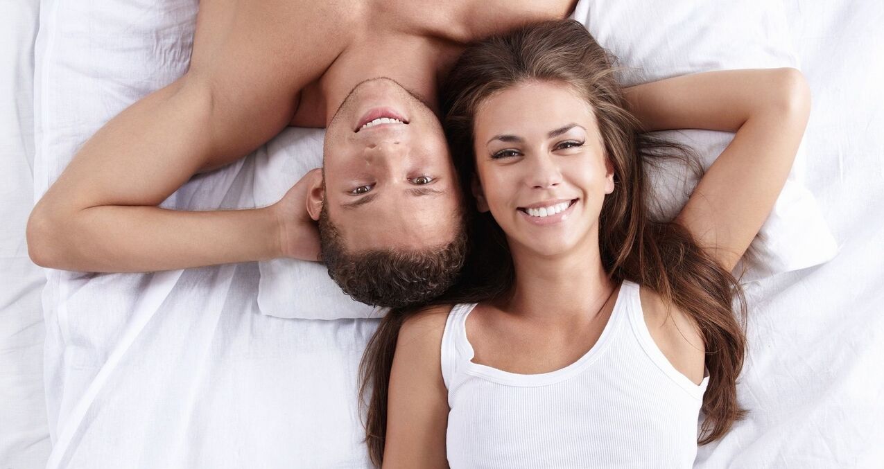A woman in bed with a man who has increased potency